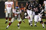CHICAGO - AUGUST 22: Mario Manningham #82 of the New York Giants runs with the ball as Alex Brown #96 of the Chicago Bears pursues during a pre-season game on August 22, 2009 at Soldier Field in Chicago, Illinois. The Bears defeated the Giants 17-3. (Photo by Jonathan Daniel/Getty Images)