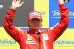 VALENCIA, SPAIN - AUGUST 23:  Kimi Raikkonen of Finland and Ferrari celebrates on the podium after finishing third in the European Formula One Grand Prix at the Valencia Street Circuit on August 23, 2009, in Valencia, Spain.  (Photo by Mark Thompson/Getty Images)