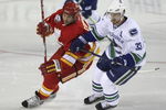 CALGARY, AB - OCTOBER 1:  Craig Conroy #24 of the Calgary Flames tries to get around Henrik Sedin #33 of the Vancouver Canucks in the second period of NHL action during the season opener on October 1, 2009 at the Pengrowth Saddledome in Calgary, Alberta, Canada. (Photo by Mike Ridewood/Getty Images)