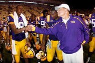 BATON ROUGE, LA - SEPTEMBER 19:  Jordan Jefferson #9 shakes hands with head coach Les Miles  of the Louisiana State University Tigers after defeating the University of Louisiana-Lafatette Ragin' Cajuns at Tiger Stadium 31-3 on September 19, 2009 in Baton Rouge, Louisiana.  (Photo by Chris Graythen/Getty Images)