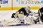 PITTSBURGH - OCTOBER 2:  Goaltender Marc-Andre Fleury #29 of the Pittsburgh Penguins attempts to cover the puck as defenseman Mark Eaton #7 of the Penguins keeps Ryan Callahan #24 of the New York Rangers away on October 2, 2009 at Mellon Arena in Pittsburgh, Pennsylvania.  (Photo by Jamie Sabau/Getty Images)