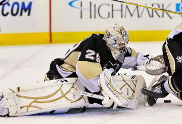 PITTSBURGH - OCTOBER 2:  Goaltender Marc-Andre Fleury #29 of the Pittsburgh Penguins attempts to cover the puck as defenseman Mark Eaton #7 of the Penguins keeps Ryan Callahan #24 of the New York Rangers away on October 2, 2009 at Mellon Arena in Pittsburgh, Pennsylvania.  (Photo by Jamie Sabau/Getty Images)