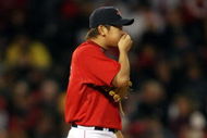 BOSTON - OCTOBER 02:  Daisuke Matsuzaka #18 of the Boston Red Sox tries to warm up his hand in the fourth inning against the Cleveland Indians on October 2, 2009 at Fenway Park in Boston, Massachusetts.  (Photo by Elsa/Getty Images)