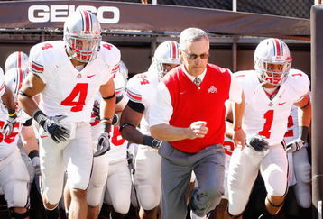 CLEVELAND - SEPTEMBER 19: Quarterback Kurt Coleman #4 and head coach Jim Tressel of the Ohio State Buckeyes jog onto the field before the game against the Toledo Rockets at Cleveland Browns Stadium on September 19, 2009 in Cleveland, Ohio. The Ohio State Buckeyes shutout the Toledo Rockets 38-0. (Photo by Gregory Shamus/Getty Images)