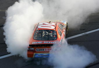 KANSAS CITY, KS - OCTOBER 03:  Joey Logano, driver of the #20 Game Stop/Our House Party Toyota, performs a burnout in celebration of winning the NASCAR Nationwide Series Kansas Lottery 300 at the Kansas Speedway on October 3, 2009 in Kansas City, Kansas.  (Photo by Todd Warshaw/Getty Images)