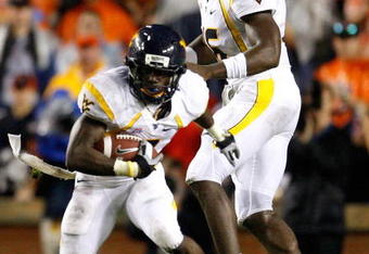 AUBURN, AL - SEPTEMBER 19:  Quarterback Jarrett Brown #16 and Noel Devine #7 of the West Virginia Mountaineers against the Auburn Tigers at Jordan-Hare Stadium on September 19, 2009 in Auburn, Alabama.  (Photo by Kevin C. Cox/Getty Images)