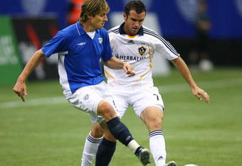 VANCOUVER, CANADA - NOVEMBER 7:  Chris Klein #7 of the Los Angeles Galaxy and Peter Vagenas #8 of the Vancouver Whitecaps battle for the ball during their exhibition soccer match against  at BC Place Stadium on November 7, 2007 in Vancouver, British Columbia, Canada.  The game finished in a scoreless tie.  (Photo By Jeff Vinnick/Getty Images)