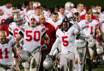 EVANSTON, IL - NOVEMBER 11:  Doug Datish #50 and Albert Dukes #5 of the Ohio State Buckeyes run off the field celebrating the Buckeyes 54-10 victory over the Northwestern Wildcats on November 11, 2006 at Ryan Field in Evanston, Illinois.  (Photo by Jonathan Daniel/Getty Images)