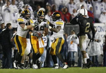 STATE COLLEGE, PA - SEPTEMBER 26:  A.J. Edds #49 of the Iowa Hawkeyes celebrates a fourth quarter interception with Pat Angerer #43 and Jeremiha Hunter #42 in front of Chaz Powell #2 of the Penn State Nittnay Lions  on September 26, 2009 at Beaver Stadium in State College, Pennsylvania. Iowa won the game 21-10.  (Photo by Gregory Shamus/Getty Images)