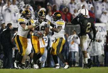STATE COLLEGE, PA - SEPTEMBER 26:  A.J. Edds #49 of the Iowa Hawkeyes celebrates a fourth quarter interception with Pat Angerer #43 and Jeremiha Hunter #42 in front of Chaz Powell #2 of the Penn State Nittnay Lions  on September 26, 2009 at Beaver Stadium in State College, Pennsylvania. Iowa won the game 21-10.  (Photo by Gregory Shamus/Getty Images)