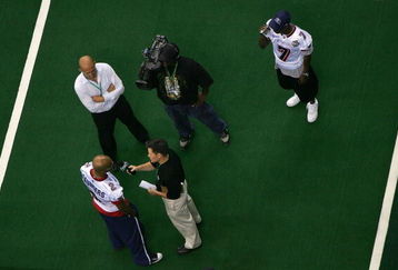 NEW ORLEANS - JULY 27:  David Saunders #2 of the Columbus Destroyers speaks with the media as teammates Josh Bush records video of the interview during ArenaBowl XXI Media Day at the New Orleans Arena on July 27, 2007 in New Orleans, Louisiana. The Destroyers will play the San Jose SaberCats in ArenaBowl XXI on Sunday July 29.  (Photo by Doug Pensinger/Getty Images for AFL)