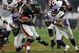 CHICAGO - OCTOBER 14: Cedric Benson #32 of the Chicago Bears breaks away from Kenechi Udeze #95 and Dwight Smith #24 of the Minnesota Vikings on October 14, 2007 at Soldier Field in Chicago, Illinois. The Vikings defeated the Bears 34-31. (Photo by Jonathan Daniel/Getty Images)