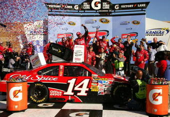 KANSAS CITY, KS - OCTOBER 04:  Tony Stewart, driver of the #14 Office Depot / Old Spice Chevrolet, celebrates with his crew in victory lane after winning the NASCAR Sprint Cup Series Price Chopper 400 presented by Kraft Foods at the Kansas Speedway on October 4, 2009 in Kansas City, Kansas.  (Photo by Jerry Markland/Getty Images for NASCAR)