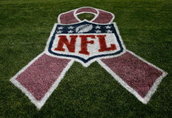 DENVER - OCTOBER 04:  The NFL logo is adorned with a pink ribbon on the sidelines as part of a program to raise awareness for breast cancer as the Dallas Cowboys face the Denver Broncos during NFL action at Invesco Field at Mile High on October 4, 2009 in Denver, Colorado. Throughout October, NFL games will feature players, coaches and referees wearing pink game apparel for the 'A Crucial Catch' program to raise awareness for breast cancer screening.  (Photo by Doug Pensinger/Getty Images)