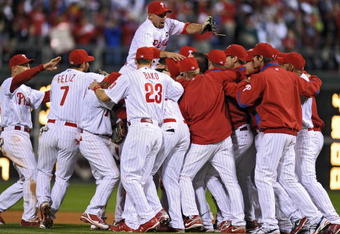 PHILADELPHIA - SEPTEMBER 30: Shane Victorino #8 of the Philadelphia Phillies jumps on top of his teammates after beating the Houston Astros 10-3 and winning the National League East on September 30, 2009 at Citizens Bank Park in Philadelphia, Pennsylvania. (Photo by Drew Hallowell/Getty Images)