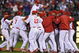 PHILADELPHIA - SEPTEMBER 30: Shane Victorino #8 of the Philadelphia Phillies jumps on top of his teammates after beating the Houston Astros 10-3 and winning the National League East on September 30, 2009 at Citizens Bank Park in Philadelphia, Pennsylvania. (Photo by Drew Hallowell/Getty Images)