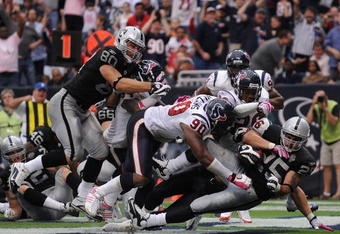 HOUSTON - OCTOBER 04:  Running back Justin Fargas #25 of the Oakland Raiders is tackled for a safety by Brian Cushing #56 of the Houston Texans at Reliant Stadium on October 4, 2009 in Houston, Texas.  (Photo by Ronald Martinez/Getty Images)