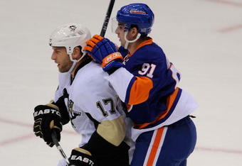 UNIONDALE, NY - OCTOBER 03:  Michael Rupp #17 of the Pittsburgh Penguins slows down John Tavares #91 of the New York Islanders in the first period of their NHL game on October 3, 2009 in Uniondale, New York.  (Photo by Paul Bereswill/Getty Images)