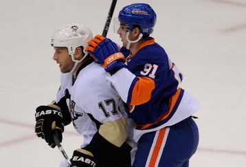 UNIONDALE, NY - OCTOBER 03:  Michael Rupp #17 of the Pittsburgh Penguins slows down John Tavares #91 of the New York Islanders in the first period of their NHL game on October 3, 2009 in Uniondale, New York.  (Photo by Paul Bereswill/Getty Images)