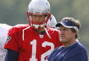 FOXBORO, MA - JULY 27: Quarterback Tom Brady #12 and coach Bill Belichick of the New England Patriots confer during training camp practice on July 27, 2007 at Gillette Stadium in Foxboro, Massachusetts. (Photo by Jim Rogash/Getty Images)