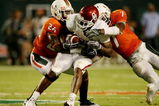 MIAMI GARDENS, FL - OCTOBER 3:  DeMarco Murray #7 of the Oklahoma Sooners gets tackled by Ray Ray Armstrong #26 and Vaughn Telemaque #7  of the Miami Hurricanes after getting first down in the second quarter of the game on October 3, 2009 at Landshark Stadium in Miami Gardens, Florida. (Photo by Doug Benc/Getty Images)