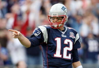FOXBORO, MA - OCTOBER 04:  Tom Brady #12 of the New England Patriots celebrates Randy Moss' touchdown catch against the Baltimore Ravens on October 4, 2009 at Gillette Stadium in Foxboro, Massachusetts. The Patriots defeated the Ravens 27-21.  (Photo by Elsa/Getty Images)