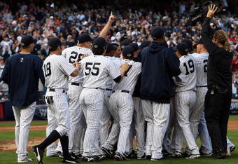 NEW YORK - SEPTEMBER 27:  The New York Yankees celebrate after defeating the Boston Red Sox on September 27, 2009 at Yankee Stadium in the Bronx borough of New York City. The Yankees won the game 4-2 to earn their 100th win of the season as well as clinching the American League Eastern Division.  (Photo by Jim McIsaac/Getty Images)