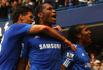 LONDON - OCTOBER 04:  Florent Malouda of Chelsea (R) celebrates with team mates Didier Drogba (C) and Michael Ballack as he scores their second goal during the Barclays Premier League match between Chelsea and Liverpool at Stamford Bridge on October 4, 2009 in London, England.  (Photo by Ian Walton/Getty Images)