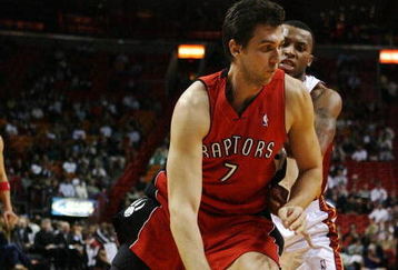 MIAMI - NOVEMBER 19:  Andrea Bargnani #7 of the Toronto Raptors drives past Daequan Cook #14 of the Miami Heat at American Airlines Arena on November 19, 2008 in Miami, Florida. The Raptors defeated the Heat 101-95. NOTE TO USER: User expressly acknowledges and agrees that, by downloading and/or using this Photograph, user is consenting to the terms and conditions of the Getty Images License Agreement.  (Photo by Doug Benc/Getty Images)