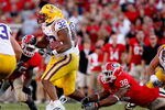 ATHENS, GA - OCTOBER 03: Charles Scott #32 of the Louisiana State University Tigers escapes a tackle by Marcus Dowtin #38 of the Georgia Bulldogs at Sanford Stadium on October 3, 2009 in Athens, Georgia. (Photo by Kevin C. Cox/Getty Images)