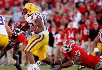 ATHENS, GA - OCTOBER 03: Charles Scott #32 of the Louisiana State University Tigers escapes a tackle by Marcus Dowtin #38 of the Georgia Bulldogs at Sanford Stadium on October 3, 2009 in Athens, Georgia. (Photo by Kevin C. Cox/Getty Images)