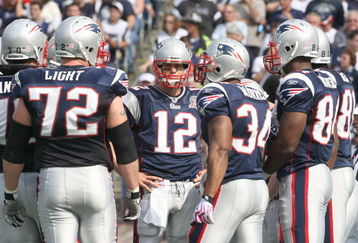 FOXBORO, MA - OCTOBER 4:  Tom Brady #12 of the New England Patriots stands in a huddle during a game against the Baltimore Ravens at Gillette Stadium on October 4, 2009 in Foxboro, Massachusetts. (Photo by Jim Rogash/Getty Images)