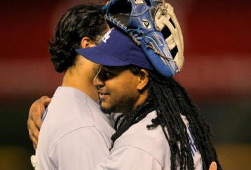 DENVER - AUGUST 25:  Manny Ramirez #99 of the Los Angeles Dodgers hugs teammate Andre Ethier #16 after Ramirez stranded him on second base against the Colorado Rockies at Coors Field on August 25, 2009 in Denver, Colorado. The Rockies defeated the Dodgers 5-4 in 10 innings.  (Photo by Doug Pensinger/Getty Images)