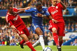 LONDON - OCTOBER 04:  Martin Skrtel (R) and Jamie Carragher of Liverpool (L) tussle with Didier Drogba of Chelsea during the Barclays Premier League match between Chelsea and Liverpool at Stamford Bridge on October 4, 2009 in London, England.  (Photo by Ian Walton/Getty Images)