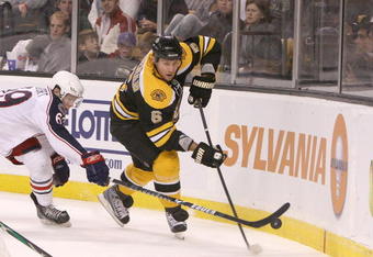 BOSTON, MA - SEPTEMBER 26: Dennis Wideman #6 of the Boston Bruins is pressed by Matt Calvert #69 of the Columbus Blue Jackets at the TD Banknorth Garden during preseason play on September 26, 2009 in Boston, Massachusetts.(Photo by Jim Rogash/Getty Images)