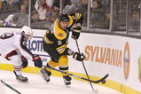 BOSTON, MA - SEPTEMBER 26: Dennis Wideman #6 of the Boston Bruins is pressed by Matt Calvert #69 of the Columbus Blue Jackets at the TD Banknorth Garden during preseason play on September 26, 2009 in Boston, Massachusetts.(Photo by Jim Rogash/Getty Images)