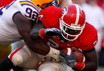 ATHENS, GA - OCTOBER 03: Drake Nevis #92 of the Louisiana State University Tigers tackles Washaun Ealey #24 of the Georgia Bulldogs at Sanford Stadium on October 3, 2009 in Athens, Georgia. (Photo by Kevin C. Cox/Getty Images)