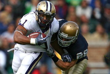 SOUTH BEND, IN - OCTOBER 03: Chris Polk #1 of the Washington Huskies tries to break away from Kyle McCarthy #28 of the Notre Dame Fighting Irish on October 3, 2009 at Notre Dame Stadium in South Bend, Indiana. (Photo by Jonathan Daniel/Getty Images)