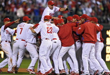 PHILADELPHIA - SEPTEMBER 30: Shane Victorino #8 of the Philadelphia Phillies jumps on top of his teammates after beating the Houston Astros 10-3 and winning the National League East on September 30, 2009 at Citizens Bank Park in Philadelphia, Pennsylvania. (Photo by Drew Hallowell/Getty Images)
