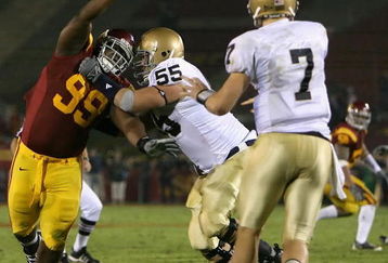 LOS ANGELES, CA - NOVEMBER 29:  Averell Spicer #99 of the USC Trojans rushes in on quarterback Jimmy Clausen #7 of the Notre Dame Fighting Irish during the game at Los Angeles Memorial Coliseum on November 29, 2008 in Los Angeles, California. The Trojans defeated the Fighting Irish 38-3.  (Photo by Christian Petersen/Getty Images)
