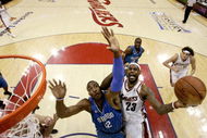 CLEVELAND - MAY 22:  LeBron James #23 of the Cleveland Cavaliers drives to the hoop against Dwight Howard #12 of the Orlando Magic in Game Two of the Eastern Conference Finals during the 2009 Playoffs at Quicken Loans Arena on May 22, 2009 in Cleveland, Ohio. NOTE TO USER: User expressly acknowledges and agrees that, by downloading and or using this photograph, User is consenting to the terms and conditions of the Getty Images License Agreement  (Photo by Jeff Haynes-Pool/Getty Images)