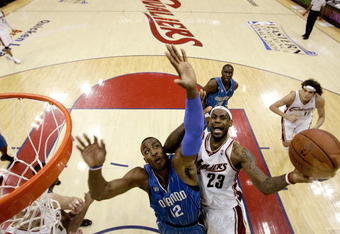 CLEVELAND - MAY 22:  LeBron James #23 of the Cleveland Cavaliers drives to the hoop against Dwight Howard #12 of the Orlando Magic in Game Two of the Eastern Conference Finals during the 2009 Playoffs at Quicken Loans Arena on May 22, 2009 in Cleveland, Ohio. NOTE TO USER: User expressly acknowledges and agrees that, by downloading and or using this photograph, User is consenting to the terms and conditions of the Getty Images License Agreement  (Photo by Jeff Haynes-Pool/Getty Images)