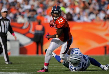DENVER - OCTOBER 04:  Brandon Marshall #15 of the Denver Broncos makes a reception as Bobby Carpenter #54 of the Dallas Cowboys makes the tackle during NFL action at Invesco Field at Mile High on October 4, 2009 in Denver, Colorado. The Broncos defeated the Cowboys 17-10.  (Photo by Doug Pensinger/Getty Images)