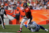 DENVER - OCTOBER 04:  Brandon Marshall #15 of the Denver Broncos makes a reception as Bobby Carpenter #54 of the Dallas Cowboys makes the tackle during NFL action at Invesco Field at Mile High on October 4, 2009 in Denver, Colorado. The Broncos defeated the Cowboys 17-10.  (Photo by Doug Pensinger/Getty Images)