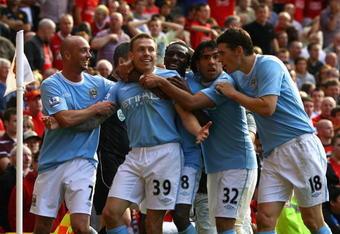 MANCHESTER, ENGLAND - SEPTEMBER 20:  Craig Bellamy of Manchester City celebrates scoring his team's third goal with his team mates during the Barclays Premier League match between Manchester United and Manchester City at Old Trafford on September 20, 2009 in Manchester, England.  (Photo by Alex Livesey/Getty Images)