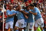 MANCHESTER, ENGLAND - SEPTEMBER 20:  Craig Bellamy of Manchester City celebrates scoring his team's third goal with his team mates during the Barclays Premier League match between Manchester United and Manchester City at Old Trafford on September 20, 2009 in Manchester, England.  (Photo by Alex Livesey/Getty Images)