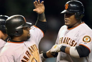 PHOENIX - SEPTEMBER 23:  Juan Uribe #5 of the San Francisco Giants is congratulated by teammate Pablo Sandoval #48 after Uribe hit a two-run home run against the Arizona Diamondbacks during the sixth inning of the major league baseball game at Chase Field on September 23, 2009 in Phoenix, Arizona.  (Photo by Christian Petersen/Getty Images)