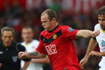 MANCHESTER, ENGLAND - OCTOBER 03:  Wayne Rooney of Manchester United goes past Lorik Cana of Sunderland during the Barclays Premier League match between Manchester United and Sunderland at Old Trafford on October 3, 2009 in Manchester, England. (Photo by Clive Brunskill/Getty Images)
