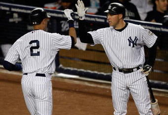 NEW YORK - SEPTEMBER 30:  Derek Jeter #2 is congratulated by Mark Teixeira #25 of the New York Yankees after he hit a solo home run in the first inning against the Kansas City Royals during the game on September 30, 2009 at Yankee Stadium in the Bronx borough of New York City.  (Photo by Jared Wickerham/Getty Images)