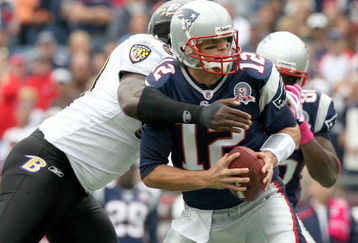 FOXBORO, MA - OCTOBER 4:  Tom Brady #12 of the New England Patriots feels the pressure of Trevor Pryce #90 of  the Baltimore Ravens at Gillette Stadium on October 4, 2009 in Foxboro, Massachusetts. (Photo by Jim Rogash/Getty Images)